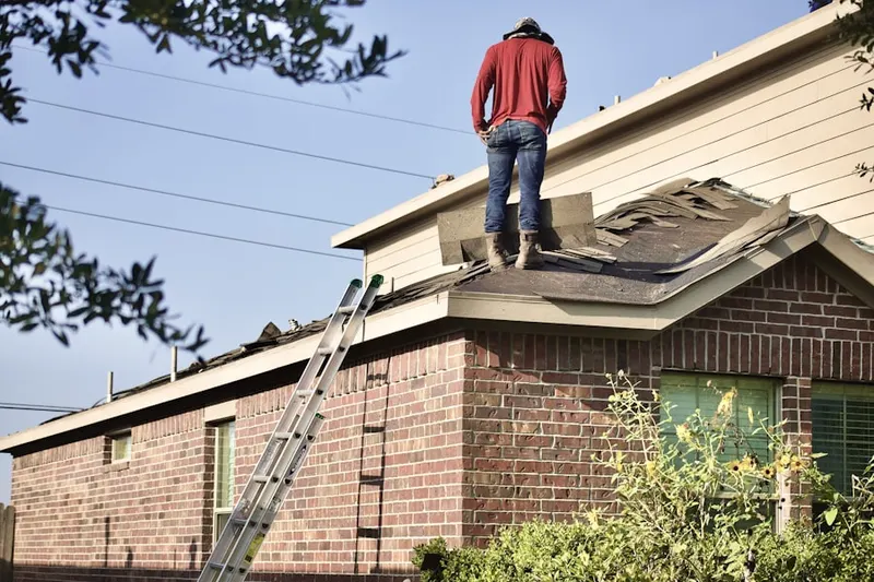 Professional roofer working on a residential roof in LaBelle